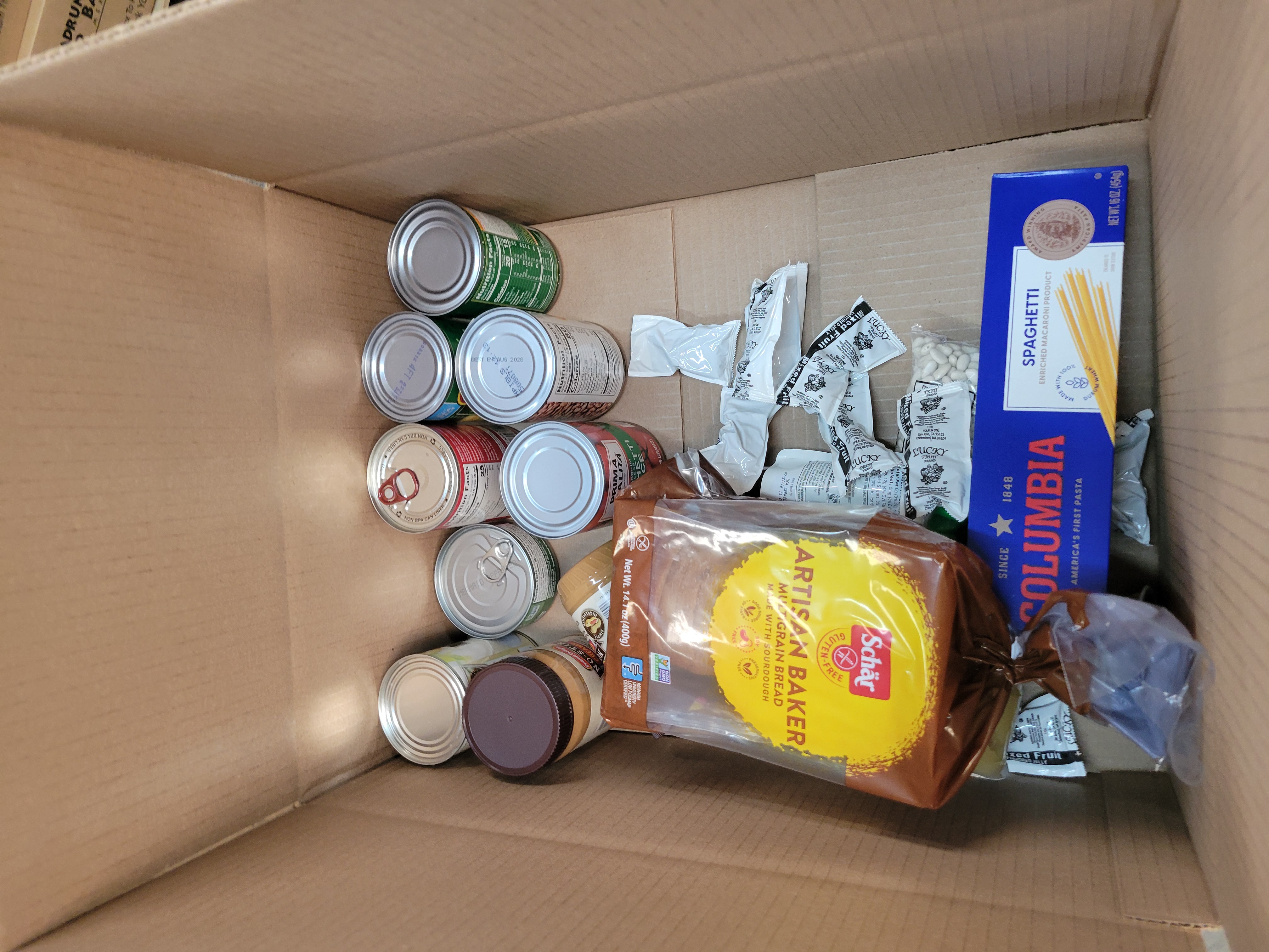 Cardboard box full of dry goods.
